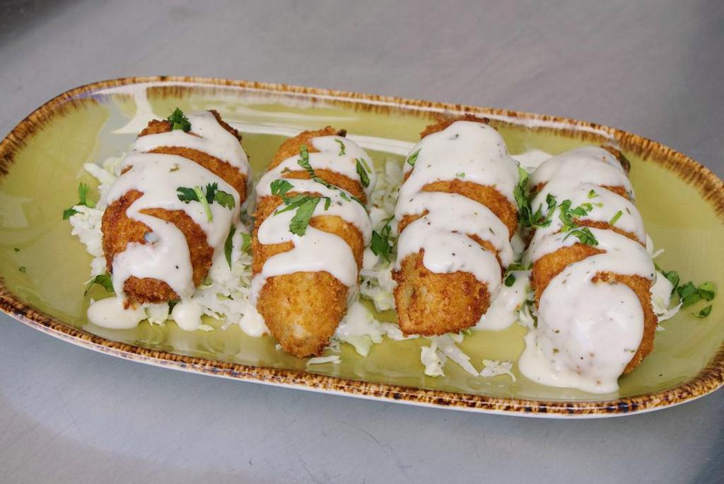 Jalapeno Poppers · Four jalapeños stuffed with Oaxaca and manchego cheeses, cilantro, el rancho dipping sauce