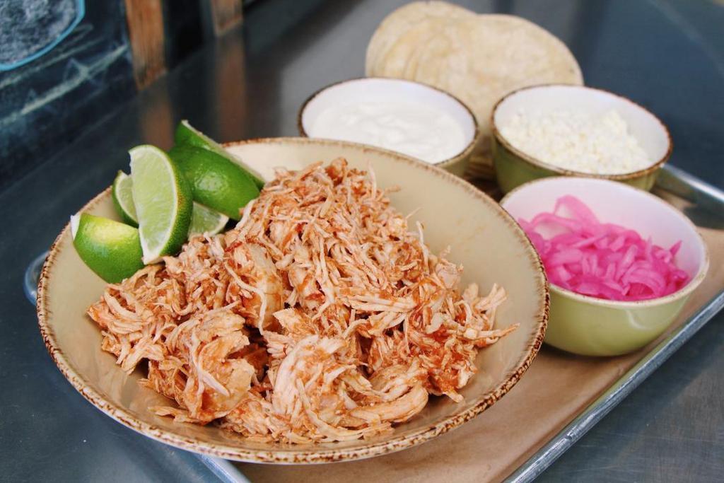 Family Style Chipotle Chicken Tacos 12 · Everything you need to assemble 12 tacos -Braised Pitman Farms shredded chicken, two white corn tortillas per taco, and all the toppings: garlic crema, marinated red onion, queso fresco