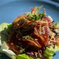 Ahi Tuna Taco · Blackened ahi tuna taco in a buttered lettuce cup topped with cabbage mix, carrot, citrus vi...