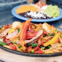 Combination Fajitas · Grilled white gulf shrimp, mary's chicken, chile de arbol flank steak,  grilled peppers & on...