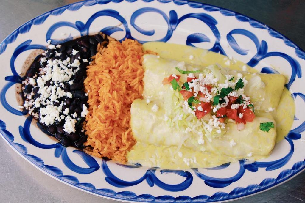 Enchiladas del Mar · Fresh shrimp, mahi-mahi, rock crab, salmon topped with house-made tomatillo sauce, melted cheese, cilantro crema, served with red rice and black beans