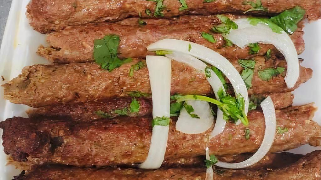 Beef Seekh Kabab · Ground beef blended with a rare selection of delicious herbs and spices. Barbecued on skewer and tenderly cooked in clay oven.