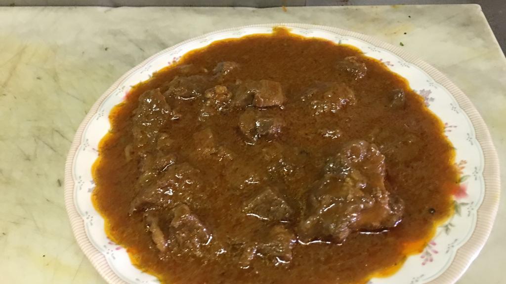 20. Bhunna Ghosht · Medium hot lamb cooked with a hint of garlic and ginger over a bed of onions and special spices.
