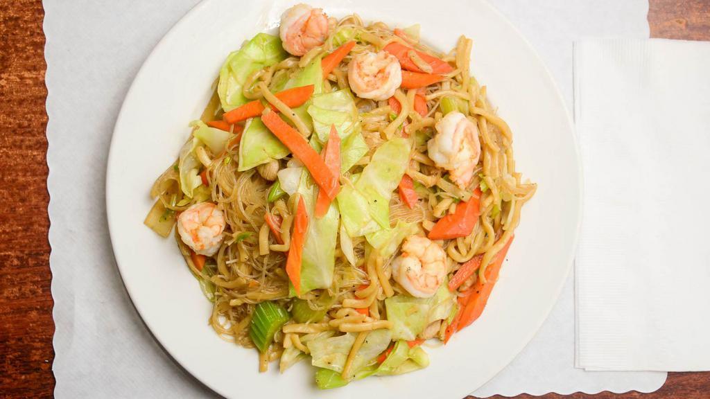 Pancit Miki Bihon · Thin rice noodles with thick egg noodles sauteed with chicken meat, shrimp and mixed vegetables topped with fried minced garlic and lemon wedges.