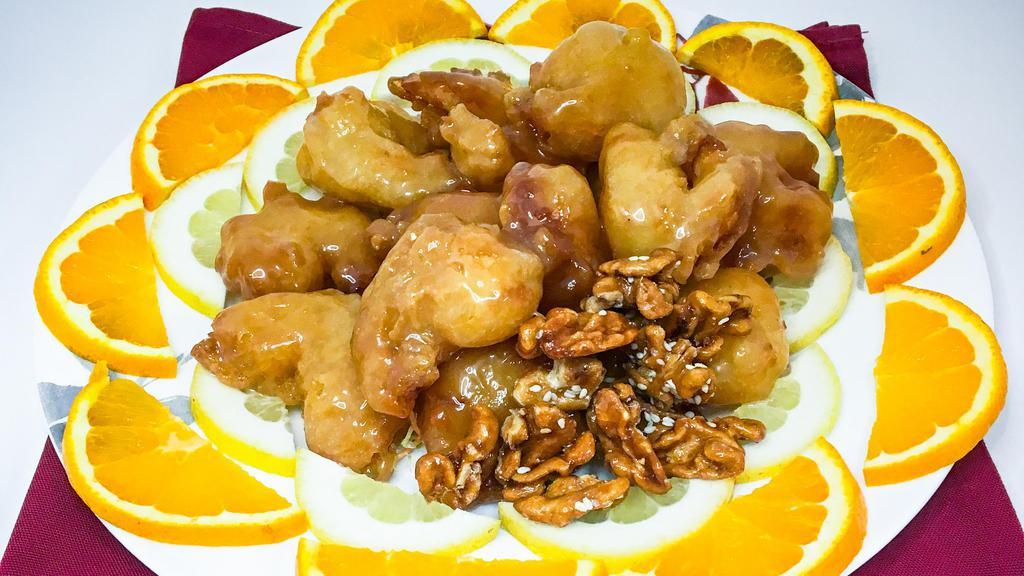 Crispy Prawns & Scallops · Fried prawns and sea scallops sauteed with roasted sesame seeds with sweet and sour sauce.