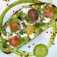 Avocado Smash · Our classic avo smash with sheep's milk feta, heirloom tomatoes & soft herbs on toasted mult...