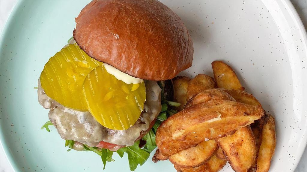 Bayside Beef Burger · Beef burger, cheddar cheese, caramelized onions, pickles, fig jam, aioli, arugula & tomato on a brioche bun, served with crispy potato wedges.. Allergens: G = Contains gluten, D = Contains dairy, E = Contains egg, S = Contains soy.