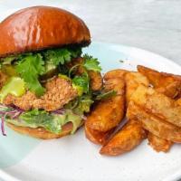 Fried Chicken Sandwich · Fried Chicken with cabbage and arugula slaw, pickles, avocash smash & chimichurri mayo on a ...