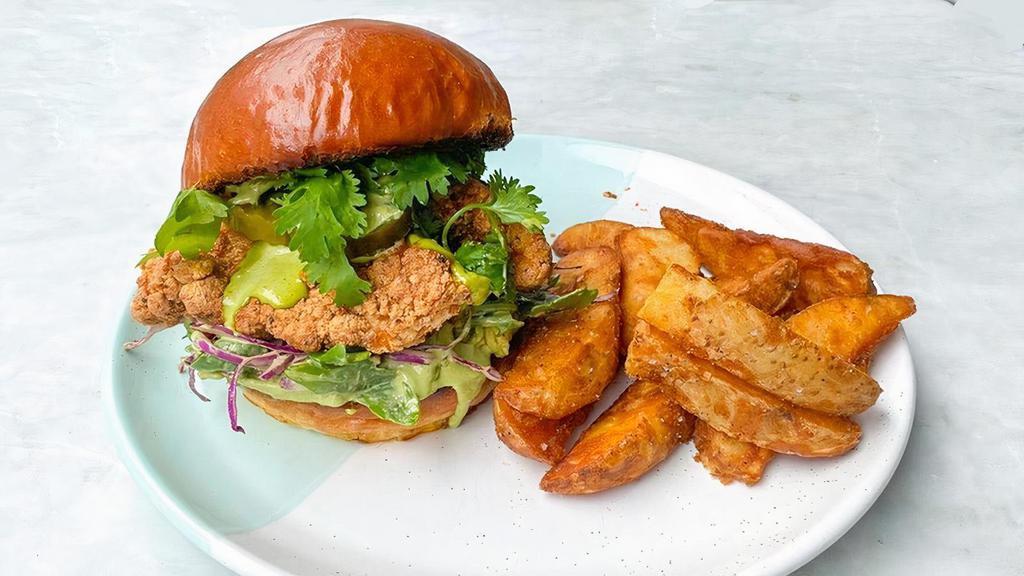 Fried Chicken Sandwich · Fried Chicken with cabbage and arugula slaw, pickles, avocash smash & chimichurri mayo on a brioche bun, served with crispy potato wedges.. Allergens: G = Contains gluten, D = Contains dairy, E = Contains egg, S = Contains soy