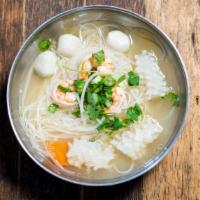 Seafood Pho · Rice noodles with chicken broth and shrimp, fishballs, and squid -- garnished with cilantro,...