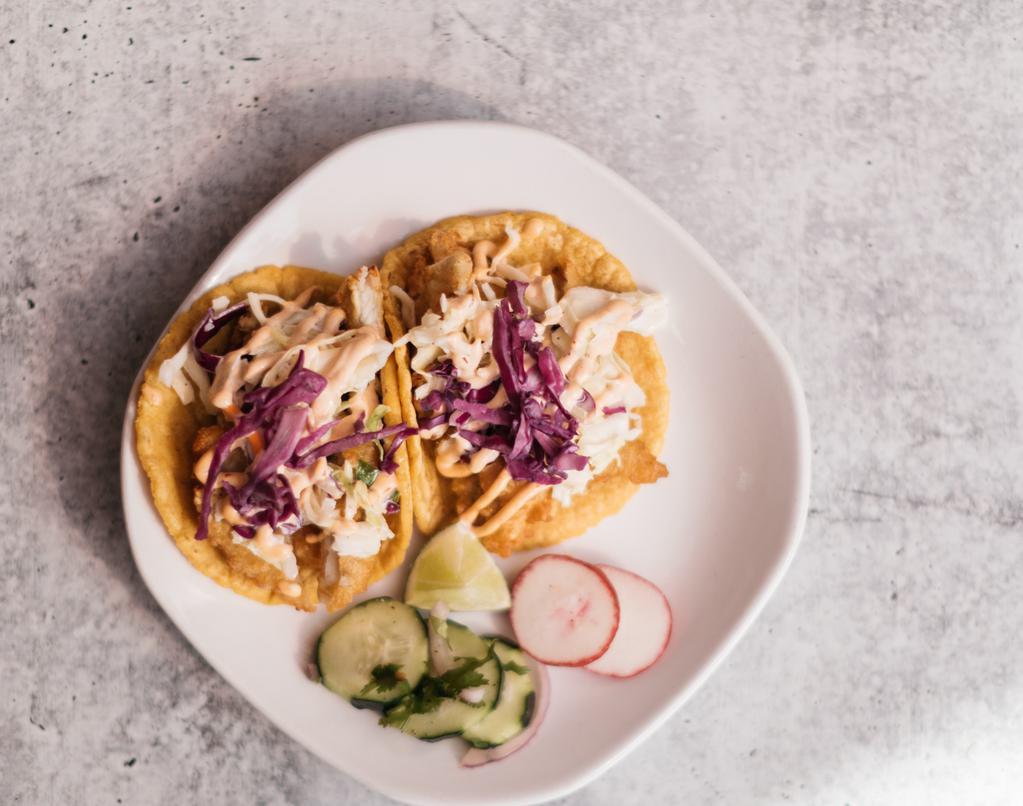 Baja Tacos  · Beer Battered Fish or Shrimp served on a corn tortilla topped with coleslaw, onions, and chipotle sour cream.