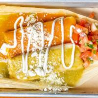 Wet Tamale  · One tamale of your choice bathed in red or green warm sauce topped with pico de gallo, queso...