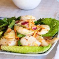 17. Calamari Salad · Spicy. Cooked calamari mixed with ginger, red onions, cilantro, chili and lemon dressing.