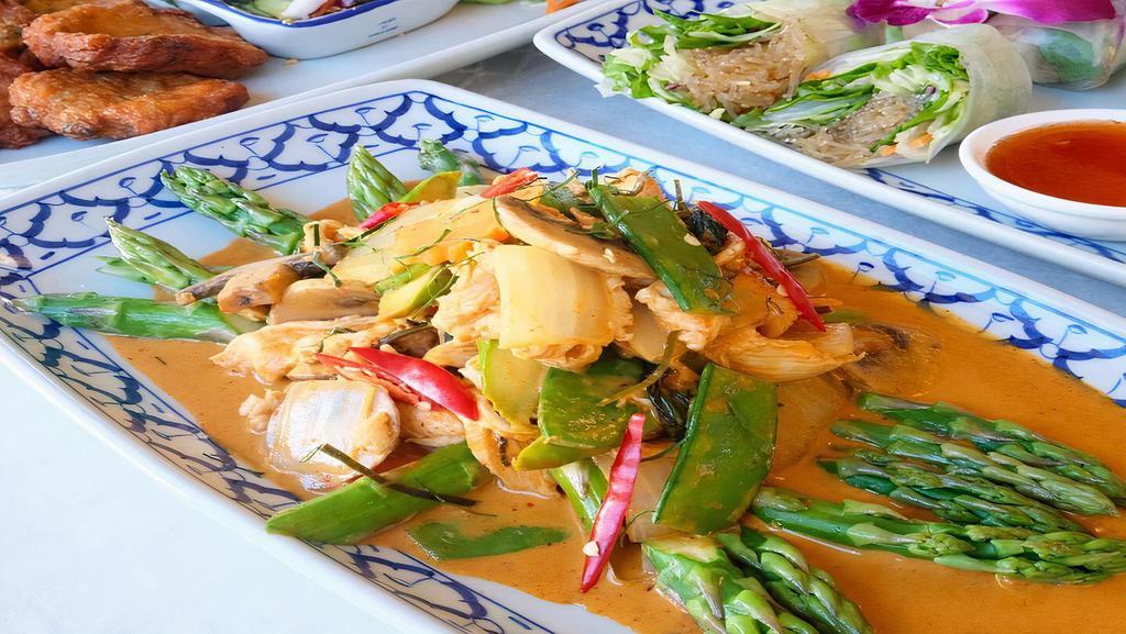 62.  Panang Chicken · Sliced chicken cooked in our hot chili paste sauce, blended with coconut milk, kaffir lime leaves, mushrooms, asparagus, snow peas and sweet basil.