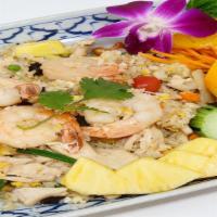 Pineapple Fried Rice · Thai Fried Rice with Chicken, Prawns, Egg, Green Peas, Raisins, Cashew Nuts, Carrots & Onions