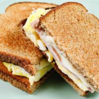 Breakfast Toast · A simple toast made with two slices of wheat bread, scrambled egg, and two slices of ham & c...