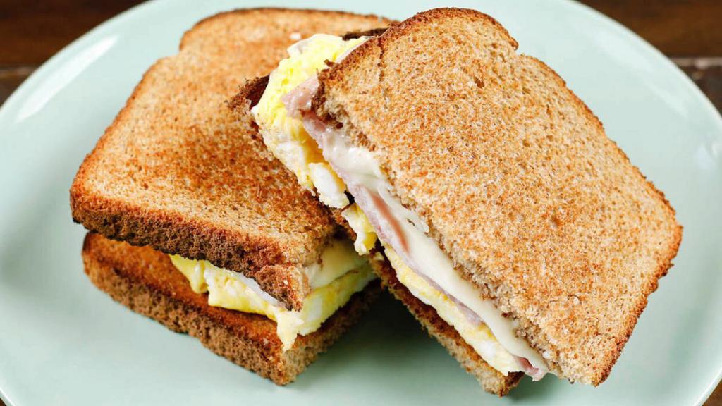 Breakfast Toast · A simple toast made with two slices of wheat bread, scrambled egg, and two slices of ham & cheese.