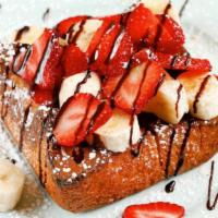Fruity Choco Nutella Toast · Toasted brick styled bread topped with a spread of nutella, slices of banana & strawberry, s...