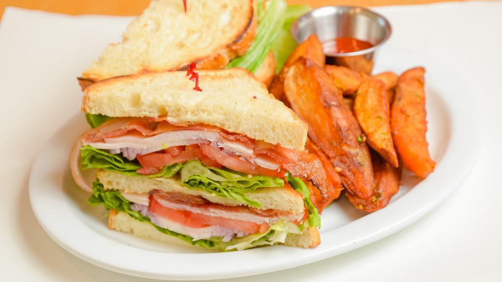 Turkey Club · A double decker sandwich with bacon, turkey, tomato, lettuce, onions, mayo on slice pullman loaf served with fries