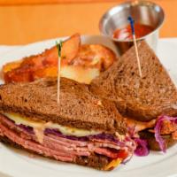 The Park Station · Corned beef sandwich on rye with sweet & sour cabbage, thousand island sauce, swiss cheese, ...