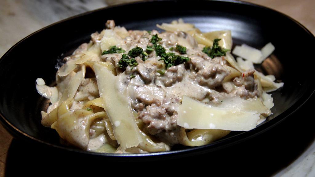 Pappardelle Sausage & Truffle Cream · House made Pappardelle served with Italian sausages,  mushrooms in black truffle cream sauce