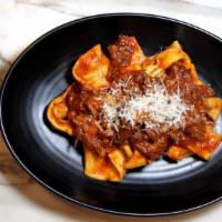 Pappardelle Alla Vaccinara · Homemade pappardelle slowly cooked oxtail ragu.