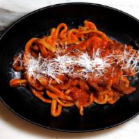 Bucatini all' Amatriciana · Bucatini pasta with guanciale, onion & mild spicy tomato sauce.