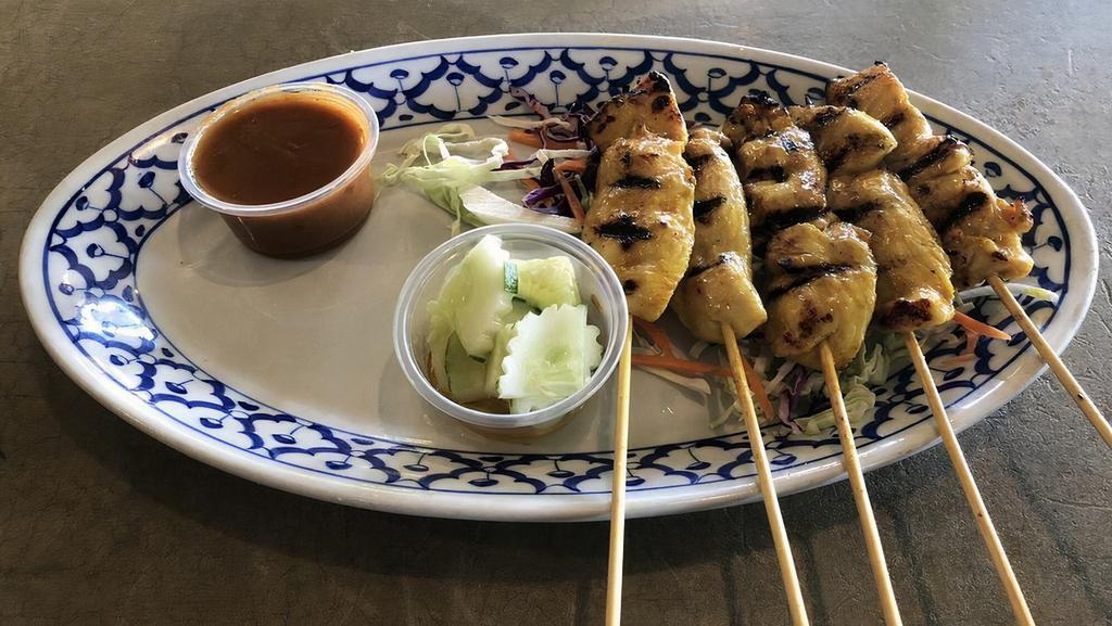 #6. Chicken Satay (on Skewers) · Grilled marinated chicken breast, served with peanut sauce and cucumber salad.