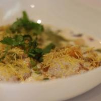 Dahi Papdi Chaat · Crispy wafers layered with potato, seven, onion, sprouts, chutney, yogurt, chickpeas, and sp...