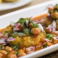 Aloo Tikki with Chana  · Potato patty served with garbanzo curry, topped with onion and chutneys.