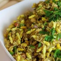 Bhel Poori · Puffed rice mixed with crispy wafers, chickpeas, potato, sprouts, onion, sev, and chutneys.
