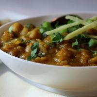 Chana Masala · White chickpeas cooked with onion, tomatoes, Indian spices and garnished with fresh cilantro.