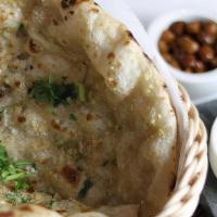 Garlic Naan · Clay oven leavened bread with garlic and herbs.
