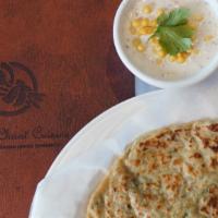 Aloo Paratha · Pan cooked whole wheat bread stuffed with spiced mashed potatoes and herbs.