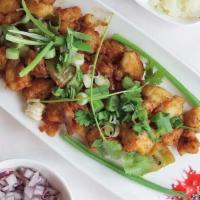 Gobi Manchurian Dry · Crispy cauliflower florets, green onion, soy, garlic and chef special Manchurian sauce.