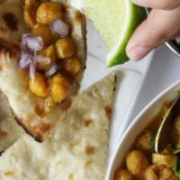 Amritsari Kulcha Chole · Leavened clay oven bread stuffed with potato and onion and served with spiced chickpeas.