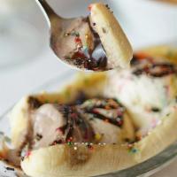 Banana Split · Three flavored ice cream scoops edged with banana and toppings with nuts.