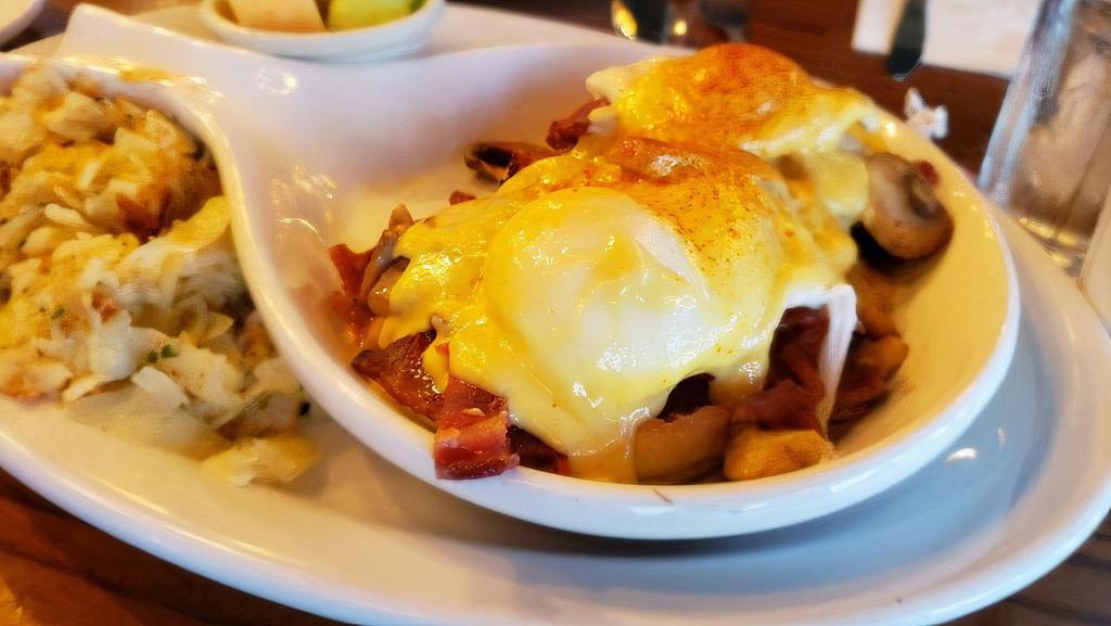 Eggs Blackstone · Bacon, tomatoes, mushrooms and two poached eggs on an english muffin, topped with hollandaise sauce. includes potatoes and fruit