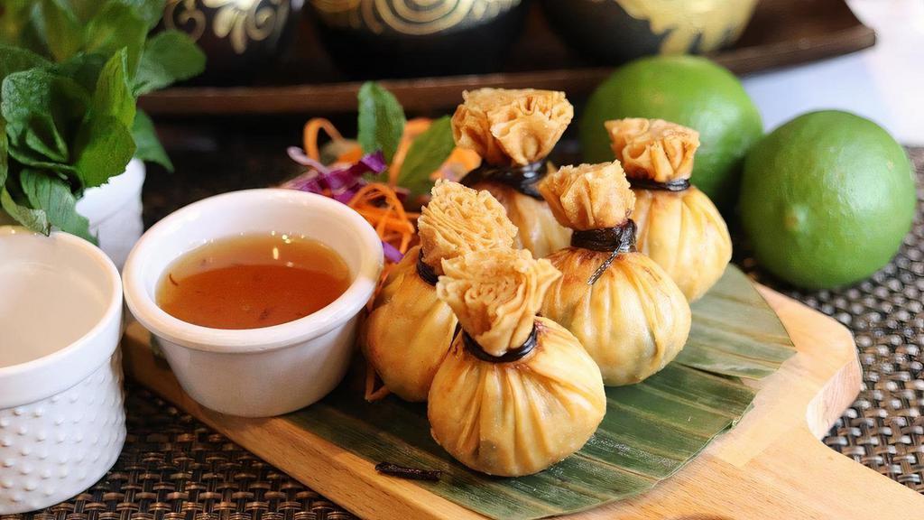 Golden Bags · Crispy wrappers stuffed with ground chicken, prawns, corn, onion, served plum sauce
