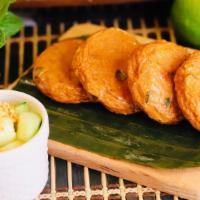 Fish Cakes · A mixture of curry paste, green bean, Kaffir lime leaves with fish paste, served with cucumb...