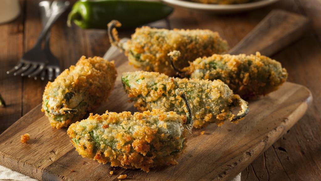 Jalapeño Poppers · 6 pcs Large jalapeños stuffed with creamy cheese, then breaded and crisped to perfection.