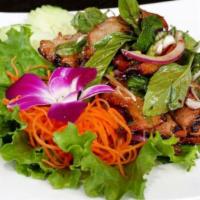 BBQ STEAK SALAD · Grilled steak served with mixed green lettuce, mint leave, tomatoes, red & green onion in sp...