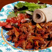 Siga Tibs · Beef marinated and stir-fried with onion, tomato, garlic, and berbere. Add mushrooms and col...