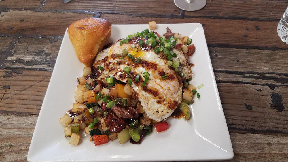 Bacon Brisket Hash · Grilled potatoes, onions, peppers with bacon and brisket, topped with two eggs and maple Dijon reduction