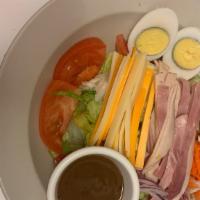 Chef's Salad · Ham, turkey, cheese, tomatoes, mushrooms, cucumber, carrots, and egg halves.