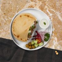 Beef Gyro Shawarma Wrap · Savory beef, hummus, lettuce, red cabbage, red onion, tahini, tzatziki, and hot sauce wrappe...