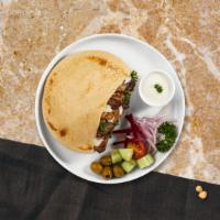 Chicken & Gyro Shawarma Wrap · Marinated chicken and beef, hummus, lettuce, red cabbage, red onion, tahini, tzatziki, and h...