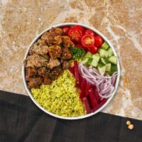 Mixed Grill Plate · Chicken and lamb shish kebabs, kofte kebab, hummus, green salad, rice, and warm pita bread.