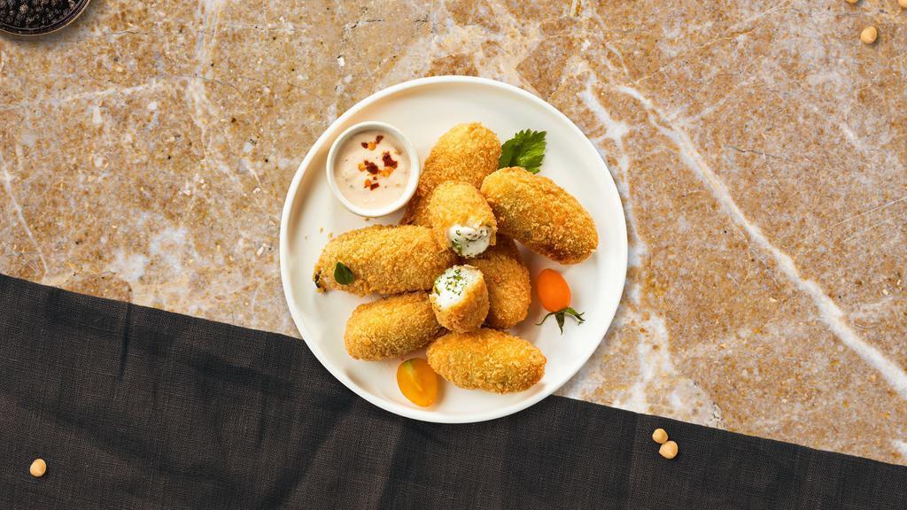 Jalapeno Poppers · Six pieces of crispy golden jalapenos stuffed with creamy cheese and served with savory marinara dipping sauce.