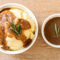 Mashed Potatoes · Creamy mashed potatoes topped with gravy.